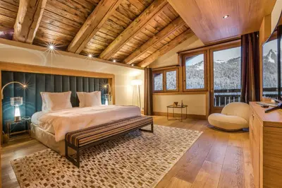 a bedroom with a bed with a wooden ceiling at Rock and Stars Megève in Megève