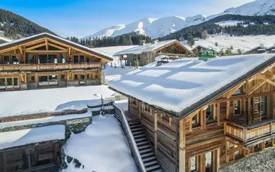 a ski lodge with snow on the roof at Rock and Stars Megève in Megève