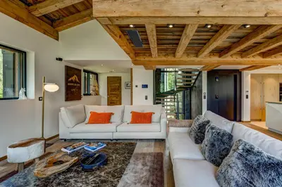 a living room with a white couch and orange pillows at Chalet Red Fox in Chamonix-Mont-Blanc
