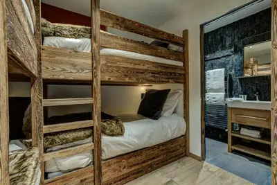 a room with two bunk beds and a sink at Chalet Red Fox in Chamonix-Mont-Blanc