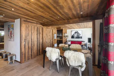 a room with a wooden ceiling with a table and chairs at Flat Simba - Megève - Mont d'Arbois in Megève