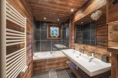 a bathroom with two sinks and a bath tub at Flat Simba - Megève - Mont d'Arbois in Megève