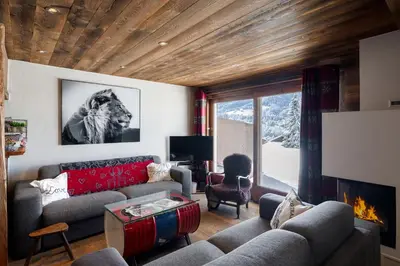 a living room with a couch and a fireplace at Flat Simba - Megève - Mont d'Arbois in Megève