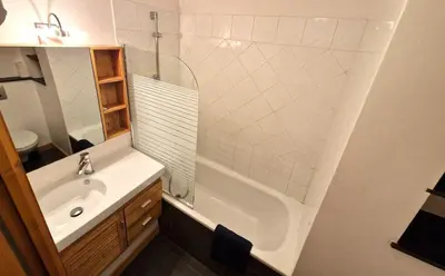 a bathroom with a sink and a tub and a shower at L'Appart de Chacha 2ch, 4pers Centre de Chamonix in Chamonix-Mont-Blanc