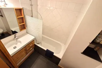 a bathroom with a sink and a shower and a tub at L'Appart de Chacha 2ch, 4pers Centre de Chamonix in Chamonix-Mont-Blanc