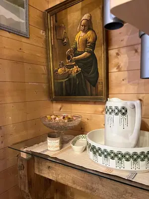 a painting of a woman eating food on a table at Ferme savoyarde rénovée 2 chambres in Les Carroz d'Araches