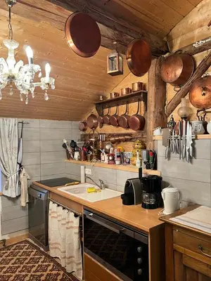 a kitchen with a sink and a counter with pots and pans at Ferme savoyarde rénovée 2 chambres in Les Carroz d'Araches