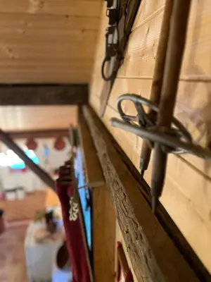 a pair of scissors attached to a wooden wall at Ferme savoyarde rénovée 2 chambres in Les Carroz d'Araches
