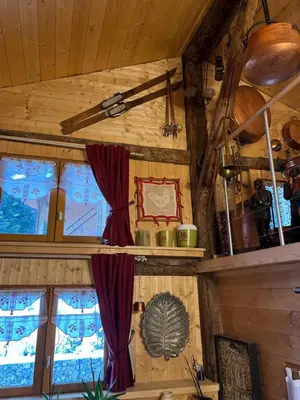 a room with two windows with red curtains at Ferme savoyarde rénovée 2 chambres in Les Carroz d'Araches