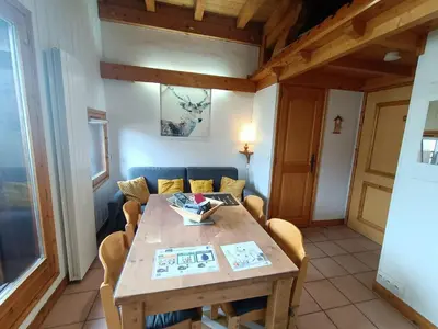 a dining room with a wooden table and chairs at Cocon familial proche télécabine in Saint-Gervais-les-Bains