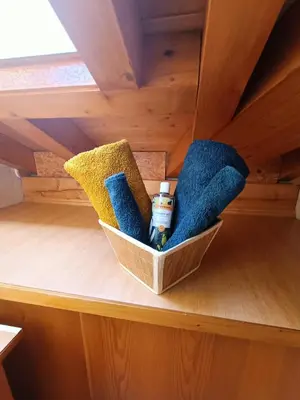 a shelf with towels and cleaning products in a room at Cocon familial proche télécabine in Saint-Gervais-les-Bains