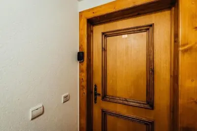 a wooden door in a room next to a wall at Cocon familial proche télécabine in Saint-Gervais-les-Bains