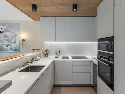 a kitchen with white cabinets and a sink at Appartement Neuf, Jardin Privé, 3 Chambres, Megève Mont d'Arbois - FR-1-569-73 in Megève