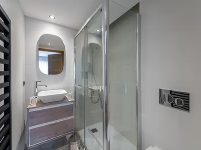a bathroom with a glass shower and a sink at Appartement Neuf, Jardin Privé, 3 Chambres, Megève Mont d'Arbois - FR-1-569-73 in Megève