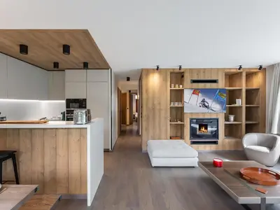 a kitchen and a living room with a fireplace at Appartement Neuf, Jardin Privé, 3 Chambres, Megève Mont d'Arbois - FR-1-569-73 in Megève