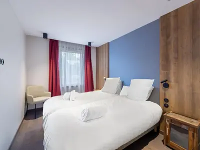 two white beds in a room with red curtains at Appartement Neuf, Jardin Privé, 3 Chambres, Megève Mont d'Arbois - FR-1-569-73 in Megève