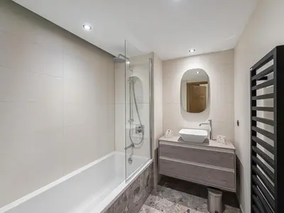 a bathroom with a tub and a sink and a shower at Appartement Neuf, Jardin Privé, 3 Chambres, Megève Mont d'Arbois - FR-1-569-73 in Megève