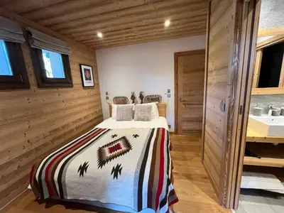 a bedroom with a bed and a sink at Chalet les 3 cerfs in Les Contamines-Montjoie