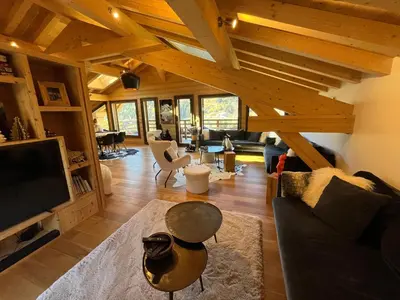 a living room with a couch and a table at Chalet les 3 cerfs in Les Contamines-Montjoie