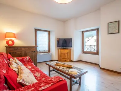 a building with a snow covered mountain in the background at Apartment Le Pavillon-3 by Interhome in Chamonix-Mont-Blanc