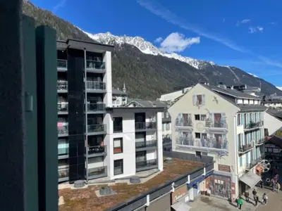 a large white building with stairs in front of it at Apartment Le Pavillon-3 by Interhome in Chamonix-Mont-Blanc