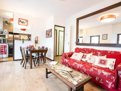 a dining room table with plates and glasses on it at Apartment Le Pavillon-3 by Interhome in Chamonix-Mont-Blanc