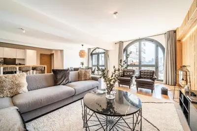 a living room with a couch and a table at Apartment Le Gui Chamonix - BY EMERALD STAY in Chamonix-Mont-Blanc