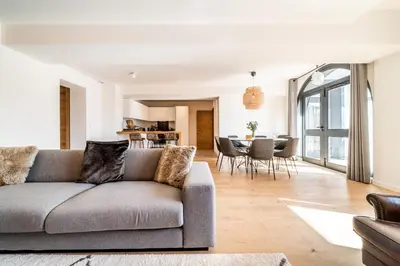 a living room with a couch and a table at Apartment Le Gui Chamonix - BY EMERALD STAY in Chamonix-Mont-Blanc