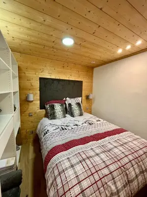 a bedroom with a bed in a wooden cabin at Megeve centre in Megève