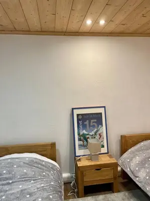 a bedroom with two beds and a picture on a wall at Megeve centre in Megève