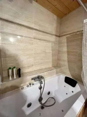 a large white bath tub in a bathroom at Megeve centre in Megève