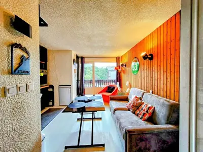 a living room with a couch and a table at Le Mazots, Balcon, Parking, Proche Pistes in Arâches-la-Frasse
