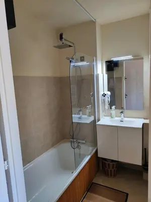 a bathroom with a shower and a tub and a sink at Le Mazots, Balcon, Parking, Proche Pistes in Arâches-la-Frasse