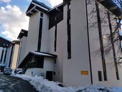 a building with snow on the side of it at Le Mazots, Balcon, Parking, Proche Pistes in Arâches-la-Frasse