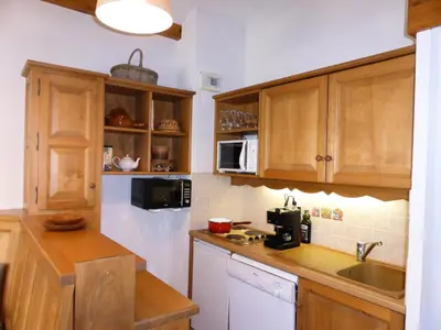 a kitchen with wooden cabinets and a sink at Résidence Palmes D'or - Palmes d'Or B33 MAE-5784 in Les Contamines-Montjoie