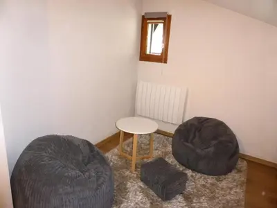 a room with two ottomans and a table and two chairs at Résidence Palmes D'or - Palmes d'Or B33 MAE-5784 in Les Contamines-Montjoie