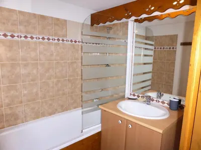 a bathroom with a sink and a mirror and a tub at Résidence Palmes D'or - Palmes d'Or B33 MAE-5784 in Les Contamines-Montjoie