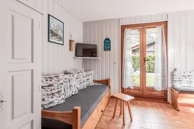 a living room with a couch and a tv at Lilas - Awesome view of the Mont-Blanc Range in Les Houches