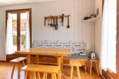 a dining room with a wooden table and chairs at Lilas - Awesome view of the Mont-Blanc Range in Les Houches