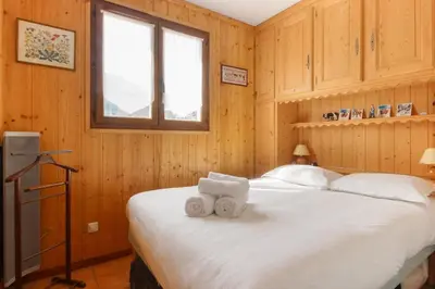a bedroom with a bed with two towels at Lilas - Awesome view of the Mont-Blanc Range in Les Houches
