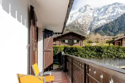 a balcony with chairs and a view of a mountain at Lilas - Awesome view of the Mont-Blanc Range in Les Houches