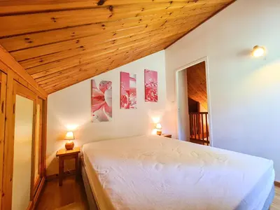 a bedroom with a large white bed with two lamps at Chalet confortable à Flaine avec poêle et WIFI - FR-1-425-198 in Arâches-la-Frasse