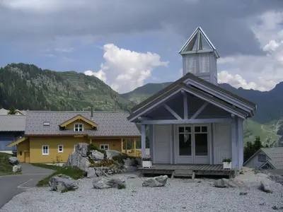 a church with a steeple on top of a building at Chalet confortable à Flaine avec poêle et WIFI - FR-1-425-198 in Arâches-la-Frasse