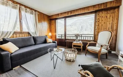 a living room with a couch and a large window at Résidence Soleil D'arbois - Anemones - Soleil d'Arbois Anémones 507 MAE-7774 in Saint-Gervais-les-Bains