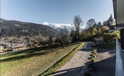 a view of a road with mountains in the background at Résidence Soleil D'arbois - Anemones - Soleil d'Arbois Anémones 507 MAE-7774 in Saint-Gervais-les-Bains