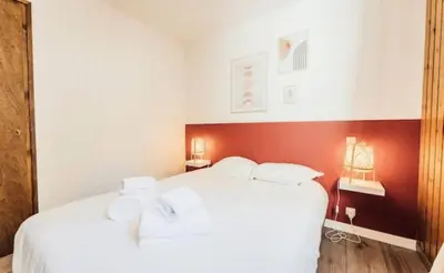 a bedroom with a white bed with white pillows at Résidence Soleil D'arbois - Anemones - Soleil d'Arbois Anémones 507 MAE-7774 in Saint-Gervais-les-Bains
