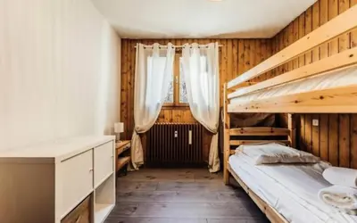 a bedroom with two bunk beds and a desk at Résidence Soleil D'arbois - Anemones - Soleil d'Arbois Anémones 507 MAE-7774 in Saint-Gervais-les-Bains