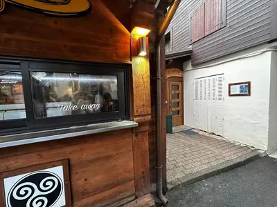 a building with a window of a coffee shop at Pti bout villlage Megeve in Megève