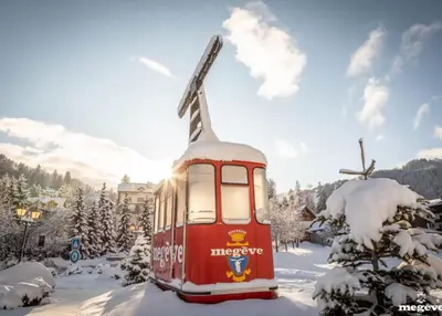 a red train in the snow with snow covered trees at Luxury Wood Megeve village in Megève