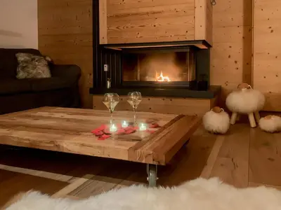 a living room with a coffee table and a fireplace at Luxury Wood Megeve village in Megève